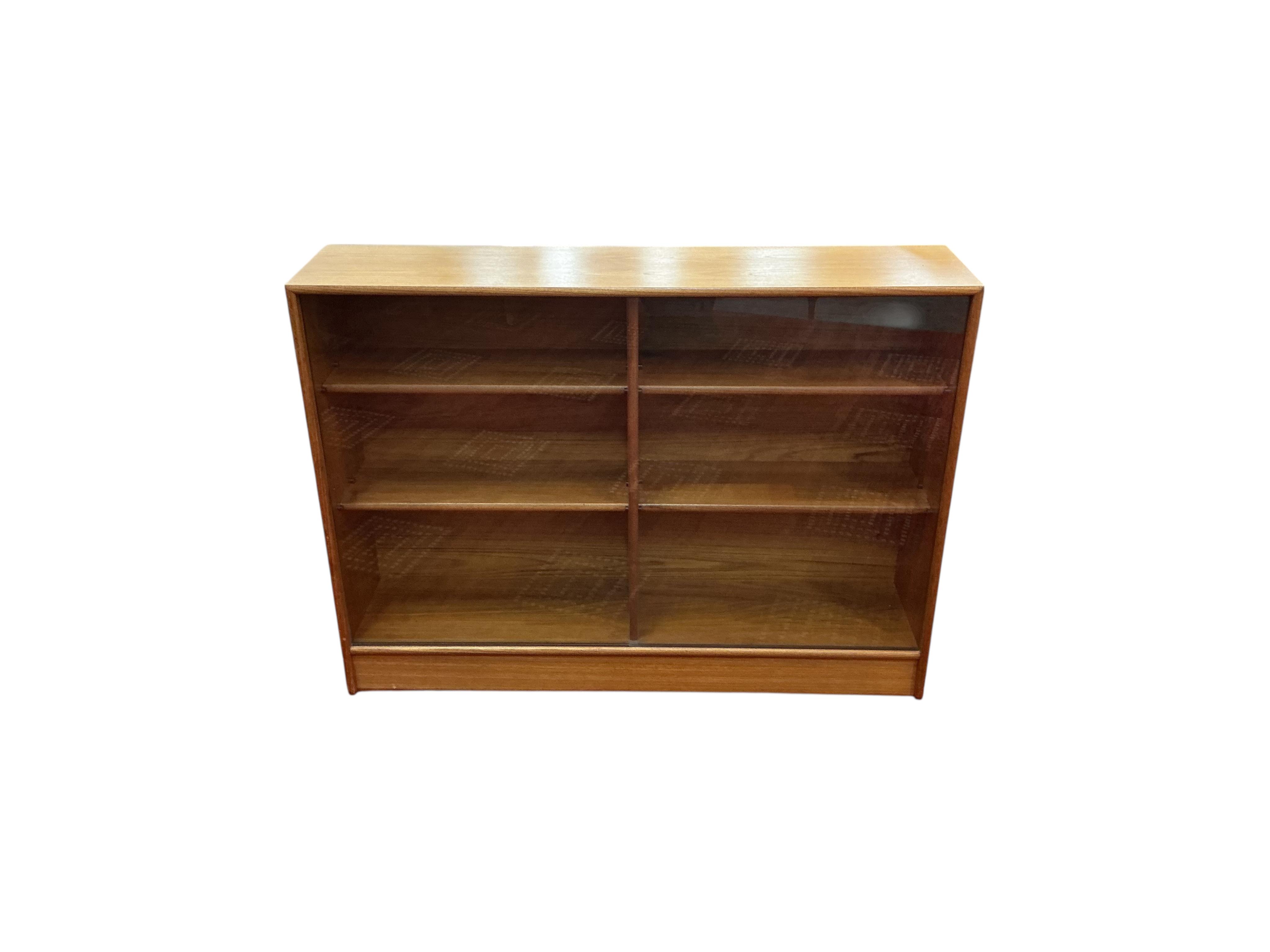 A mid century glazed teak bookcase, width 122cm, depth 28cm, height 90cm